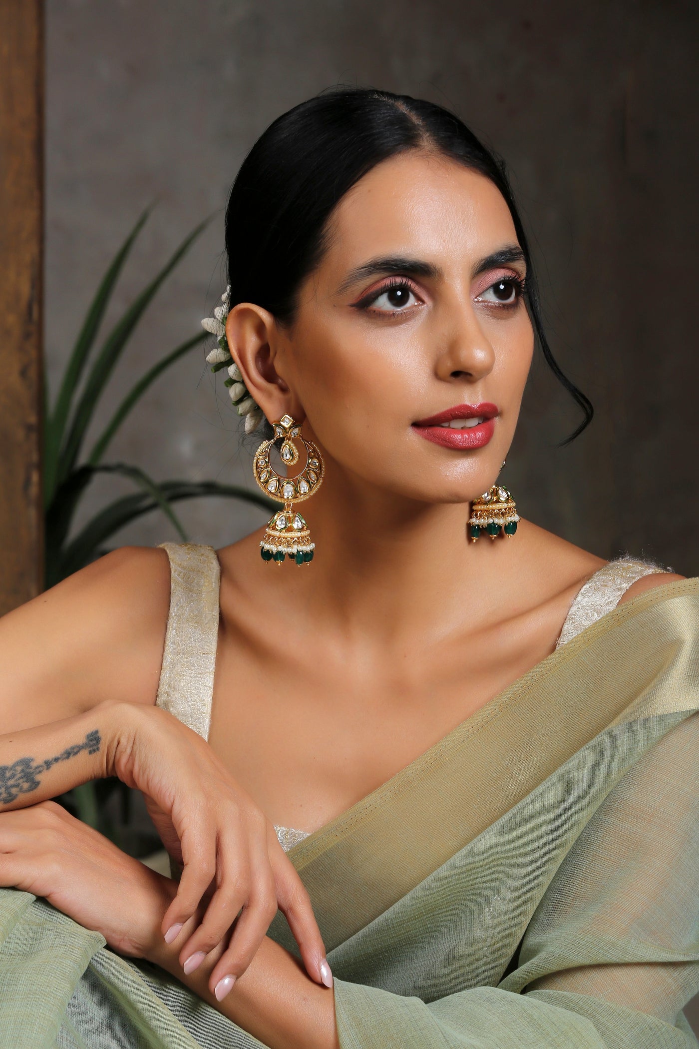 Triya Green Gold Plated Kundan Jhumka Earrings